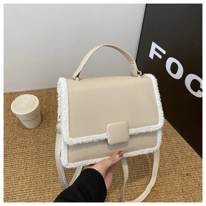 Beige faux leather crossbody bag with white faux fur trim and adjustable strap