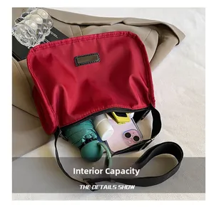 Red nylon crescent bag interior showing large capacity for umbrella and phone