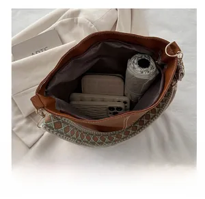 Interior view showing large capacity for phone and umbrella in brown bucket bag
