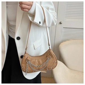 Detailed shot of caramel faux crocodile underarm bag with silver chain and rivet accents