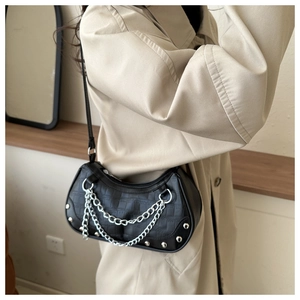 Detail of black crescent armpit bag with crocodile pattern and double silver chains