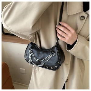 Détail du sac hobo noir à motif croco avec chaînes argentées et rivets décoratifs