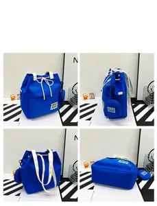 Detail view of Klein blue Japanese canvas tote with beige drawstrings and letter patches