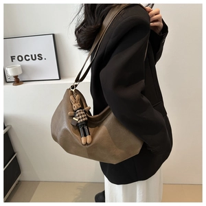 Brown pleated hobo bag with cute bunny pendant and wide shoulder strap detail
