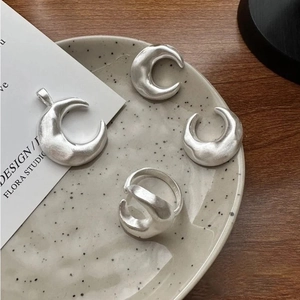Minimalist moon-themed silver jewelry set with brushed texture necklace and rings