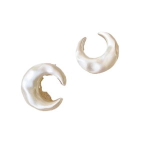 French vintage crescent earrings with a pearly satin finish on a white background