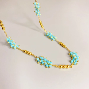 Chic gold chain necklace with light blue beaded clusters for women in minimalist style