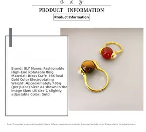 Detail view of rotating ring with red agate and tiger eye stones in gold plating