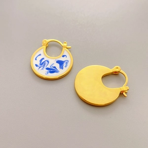Fashionable blue and white porcelain enamel hoop earrings in 18K gold plated brass finish
