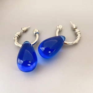 Vintage silver-tone twist hoop earrings featuring elegant deep blue teardrop pendants