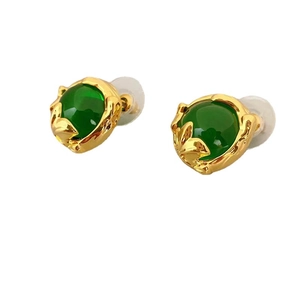 Emerald green gemstone stud earrings with leaf-shaped golden setting on white background