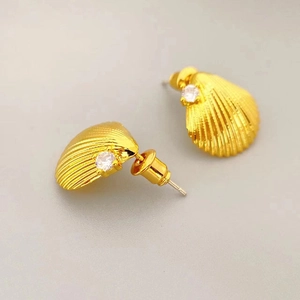 Elegant gold shell earrings with clear cubic zirconia stud on white background