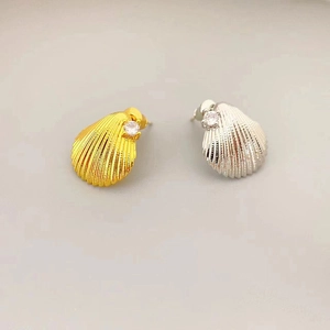Minimalist shell shaped stud earrings in gold and silver finish with sparkling zircon stones