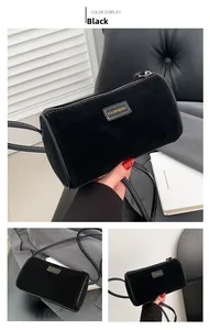 Vue détaillée du sac cylindre en daim noir avec étiquette en cuir de marque JIA SHI QING