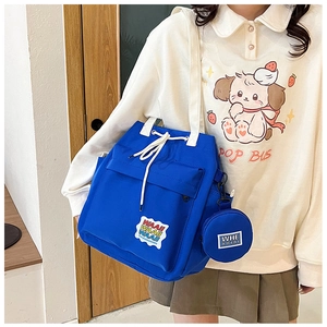 Blue canvas bucket bag with drawstring closure and detachable mini round coin purse