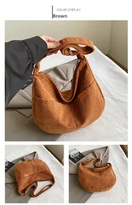 Detail of brown corduroy crescent bag with SPORT logo tag and adjustable shoulder strap