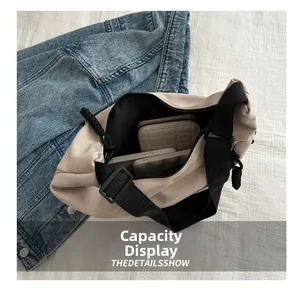 Detail showing spacious interior of beige canvas tote bag with phone and wallet inside