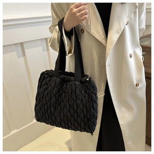 Detail der schwarzen gesteppten Puffer-Tasche mit verstellbarem Kordelzug und Textur