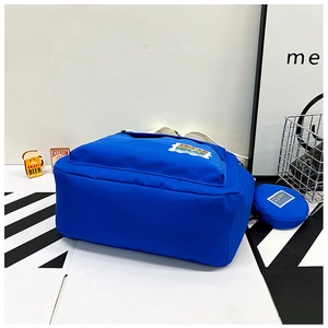 Detail of royal blue canvas bucket bag showing large capacity and small round coin purse
