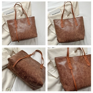 Detail view of large vintage caramel brown tote bag with retro oil leather texture