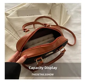 Top view of two-tone crossbody bag showing spacious interior for phone and wallet
