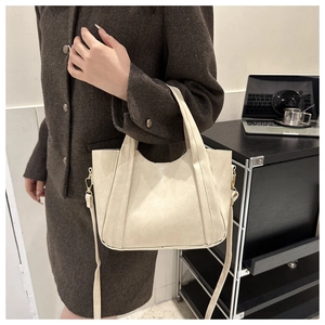 Chic beige faux leather tote bag with gold hardware and adjustable strap for women