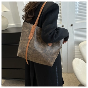 On-body shot of a large vintage brown oil leather tote bag for daily casual use