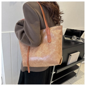 Retro brown faux leather tote bag with a spacious interior for stylish urban commuting