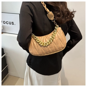 Detail of khaki quilted shoulder bag with chic golden chain and matching wide strap