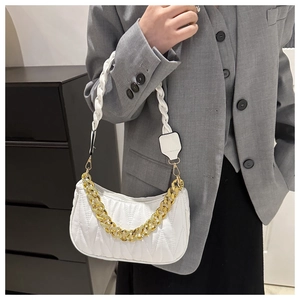Close-up of white pleated PU leather underarm bag with gold chain and woven strap