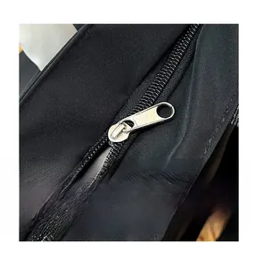 Close-up of the smooth metal zipper and durable nylon fabric on this black shoulder bag