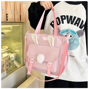 Detail view of pink nylon tote bag with 3D bunny ears and plush pom pom decoration