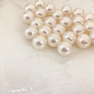 Classic round high-luster creamy white pearl earrings with a vintage minimalist design
