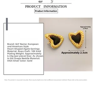 Detail showing heart-shaped earrings with black onyx inlay and 18K gold plated finish