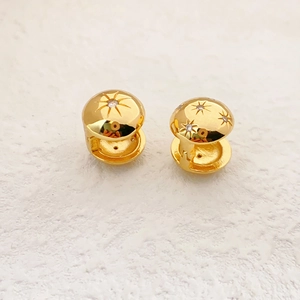 Polished gold double-sided spherical stud earrings with star engraving and cubic zirconia