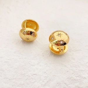 Elegant 18K gold-plated hoop earrings featuring etched starburst patterns and cubic zirconia