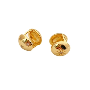 Gold huggie hoop earrings with engraved star pattern and zircon stones on white background
