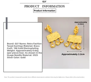 Detailed view of vintage gold drop earrings with tassels and sparkling zircon stones