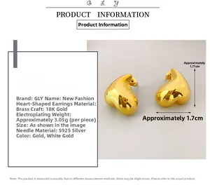Macro detail of heart-shaped brass earrings with 18K gold plating and S925 silver posts
