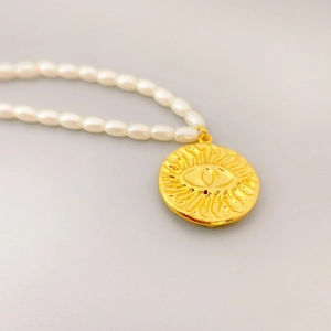 18K gold plated brass necklace with white seed pearls and evil eye sun pendant