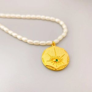 Elegant 18K gold-plated seed pearl necklace with a vintage sunburst evil eye pendant