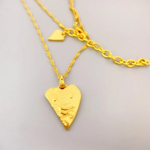 Golden irregular heart pendant necklace with smiling face engraving in luxury style