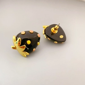 Elegant strawberry earrings in black resin with gold leaf details and silver studs