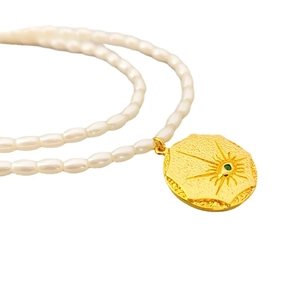 French vintage pearl necklace with 18k gold plated sunburst pendant and green gemstone