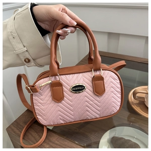 Chic quilted pink handbag with brown leather straps and metal brand plate