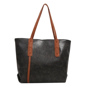 Retro grey tote bag with brown handles and vintage cracked texture from front view