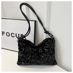 Détail des paillettes noires sur le sac porté épaule avec une bandoulière en cuir nouée