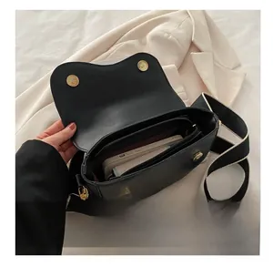 Top view detail of the black PU leather handbag showing internal storage capacity