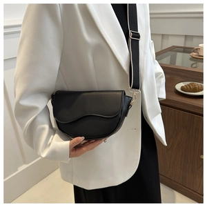 Classic black saddle bag with wave flap design and wide striped canvas shoulder strap