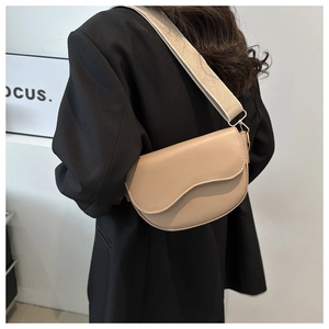 Chic beige semi-circle saddle bag with wide woven strap and wave edge flap design